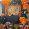 Basketball-themed birthday party setup with balloon arch and table decor