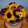 Bright golden sunflowers take center stage in this cheerful flower arrangement -