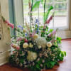 Large floor arrangement of pastel flowers with tall stems
