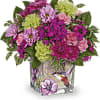 Mixed pink and green flower arrangement in a square glass vase