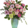 Pink and lavender flowers in a green vase