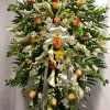 Large standing floral spray with white lilies, roses, and orchids