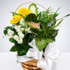 Basket arrangement with yellow daisies, white lilies, and a white ribbon bow