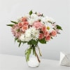 Pink and white mixed bouquet in a clear glass vase