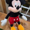 Plush Mickey Mouse toy in red shorts and yellow shoes