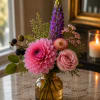 Pink and purple mixed bouquet in an amber glass vase