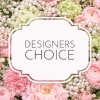 Pink and green floral arrangement with pearl accents and a "Designers Choice" sign