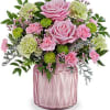 Pink roses and carnations in a pink glass vase