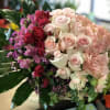 Bouquet of pink, red, and white roses with hydrangea and greenery