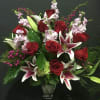 Red roses and pink lilies arranged in a clear vase