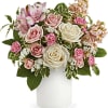 Pink and white roses with alstroemeria in a white vase