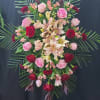 Standing floral spray with roses and lilies on an easel