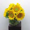 Bouquet of yellow sunflowers in a clear glass vase