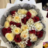 Bouquet of red and cream roses with baby's breath in black and white wrap