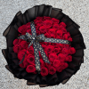 A dense dome of 50 red roses arranged in a classic rounded