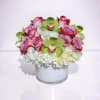 A beautifully balanced arrangement featuring soft  lavender roses, delicate white hydrangeas