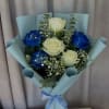 Vivid blue roses mingle with classic white roses in this Ocean Blues
