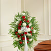 Standing floral spray with red and white flowers on an easel