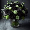 Bouquet of black and pale green roses in a clear glass vase