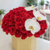 Red rose arrangement with white orchids in a beige box
