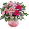 Pink roses and carnations in a pink glass vase
