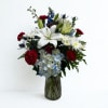 A single large white lily crowns this upright red, white, and blue