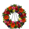 Bright and Colorful Standing Spray featuring Orange Gerber Daisys and Light Pink