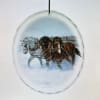 Round glass ornament with a painted horse scene