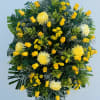 Large yellow floral standing spray with roses and chrysanthemums