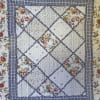 Floral patchwork quilt with blue plaid borders