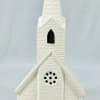White church figurine with a tall steeple and stained-glass windows