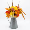 A cheerful harvest display in a galvanized metal pitcher, this fall silk