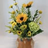 Sunflower and yellow flower arrangement in an owl-shaped ceramic pot