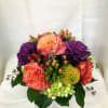 A mixture of fall colored roses, kale, pincushion protea, with accents of