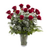 Red roses with baby's breath in a clear glass vase
