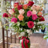 36 roses in a variety of colors with seasonal accents and foliage