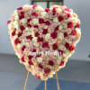 Heart-shaped rose arrangement on a stand