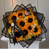 Bouquet of sunflowers and yellow roses with a graduation teddy bear