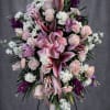 The soft blush roses, stargazer lilies, and layers of pinks, whites, and