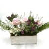 This cheerful arrangement features soft pink roses, coral carnations, sunny yellow daisies
