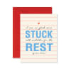 A sympathy card with the words "STUCK REST" on a red envelope