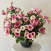 An airy and elegant arrangement featuring delicate pink lisianthus accented with fresh