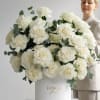 Large white rose arrangement in a white hat box with eucalyptus