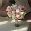 Pink and white bridal bouquet with roses and ruffled blooms