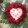 Heart-shaped rose arrangement with a heart decoration in the center