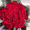 100 long stem red roses in a hand crafted Bouquet