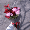 A dreamy, romantic bouquet where red roses meet pink ranunculus in a