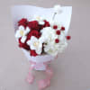 A tender and romantic bouquet where red roses meet soft white blooms