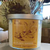 Autumn Amber soy wax candle in a glass jar with a silver lid