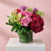 Pink and red floral arrangement in a glass vase